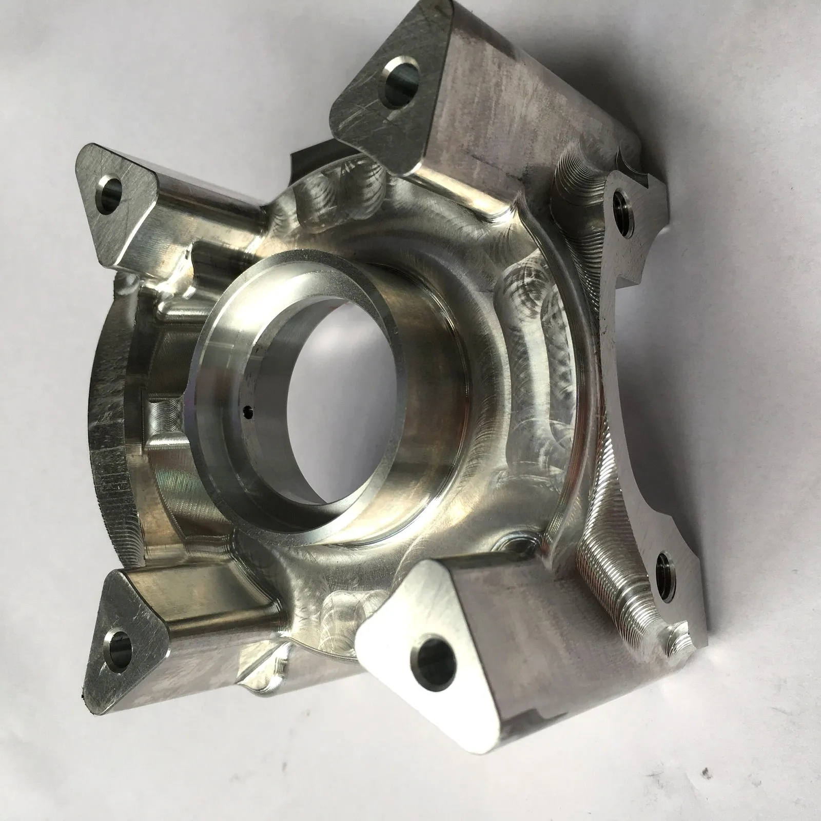 Precision machined aluminum bracket with large bore